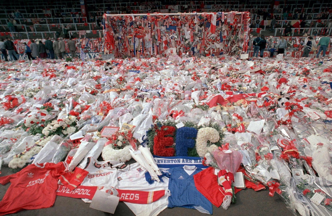Liverpool fans pay respects in flower tributes at Anfield Stadium, where 96 Liverpool fans died in the 1989 Hillsborough disaster. A judge on Wednesday dismissed a case of 2 ex-policemen and an ex-lawyer charged of perverting the course of justice. (AP)