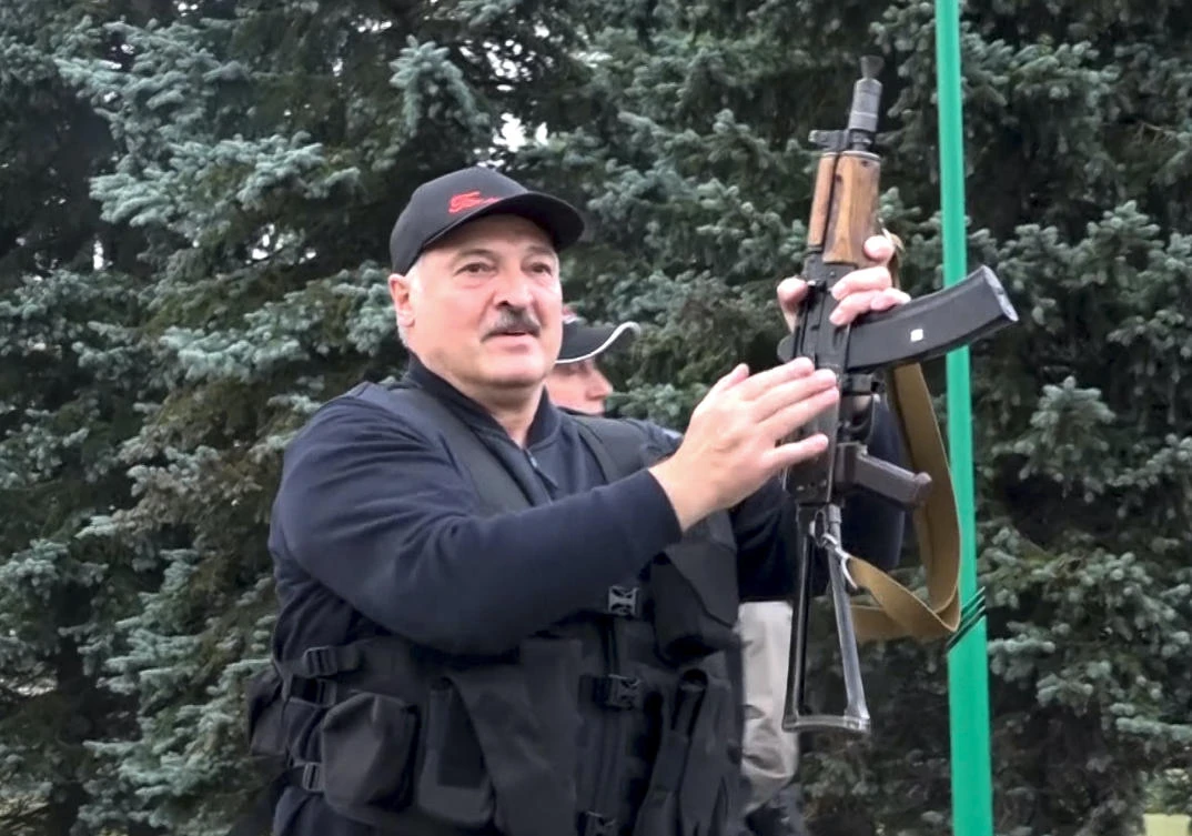 Belarus President Alexander Lukashenko armed with a Kalashnikov-type rifle near the Palace of Independence in Minsk, Belarus, Aug. 23, 2020. (AP Photo)