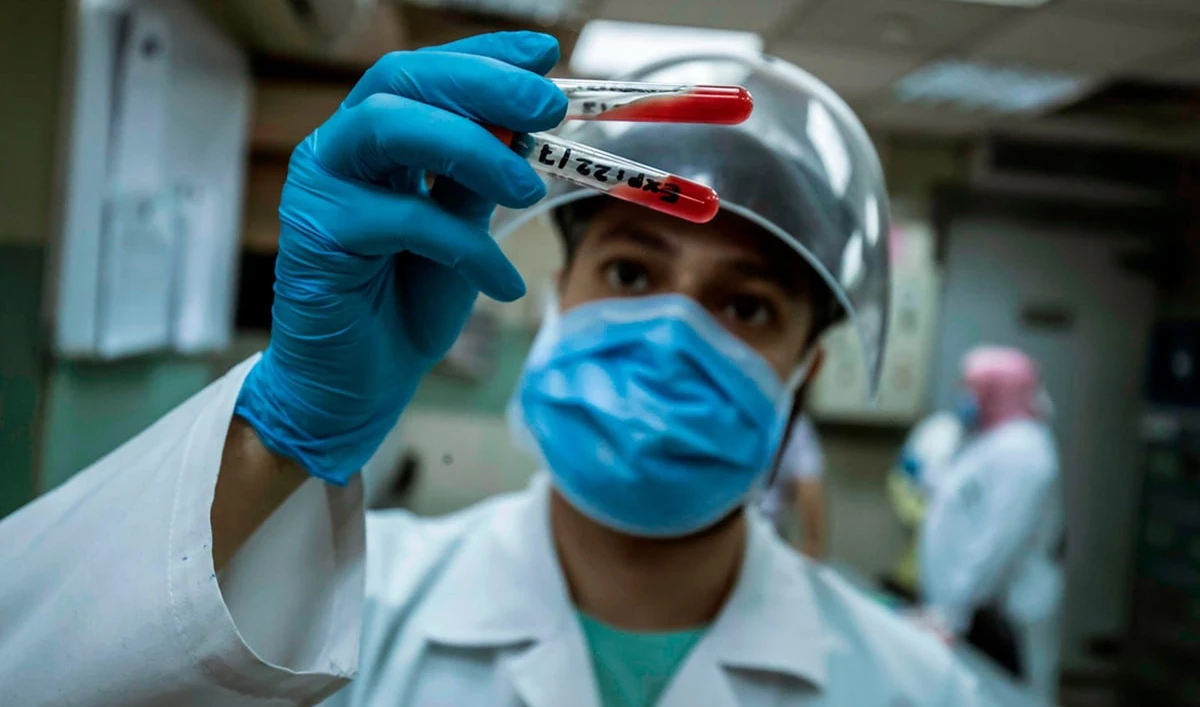 An Egyptian medical worker checks blood donated from a person who recovered from COVID-19 in Cairo. (AFP/File)