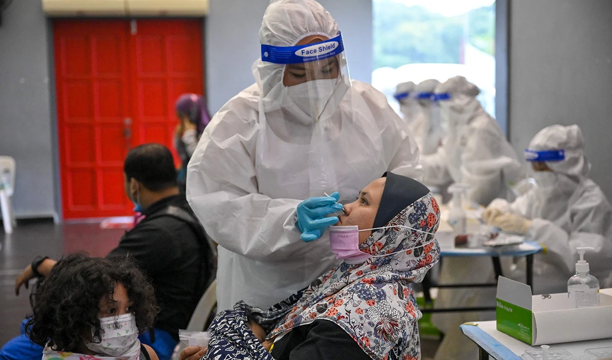 A medical worker wearing a protective suit conducts a test at a free Covid-19 coronavirus testing site in Shah Alam, on the outskirts of Kuala Lumpur, on May 27, 2021. (AFP)