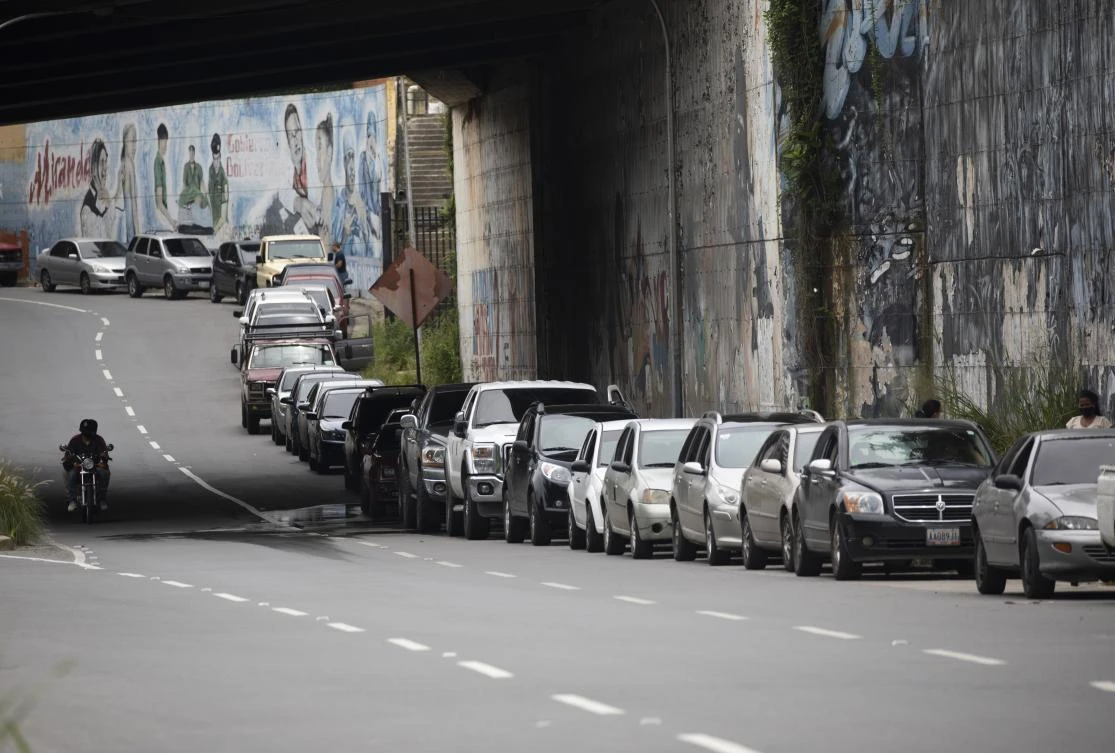 Vehicles line up near a gas station to fill their tanks in Caracas. Maritime safety mechanisms have become a powerful mechanism for tracking ships engaged in rogue activities like transporting sanctioned crude oil to places like Venezuela. (AP)
