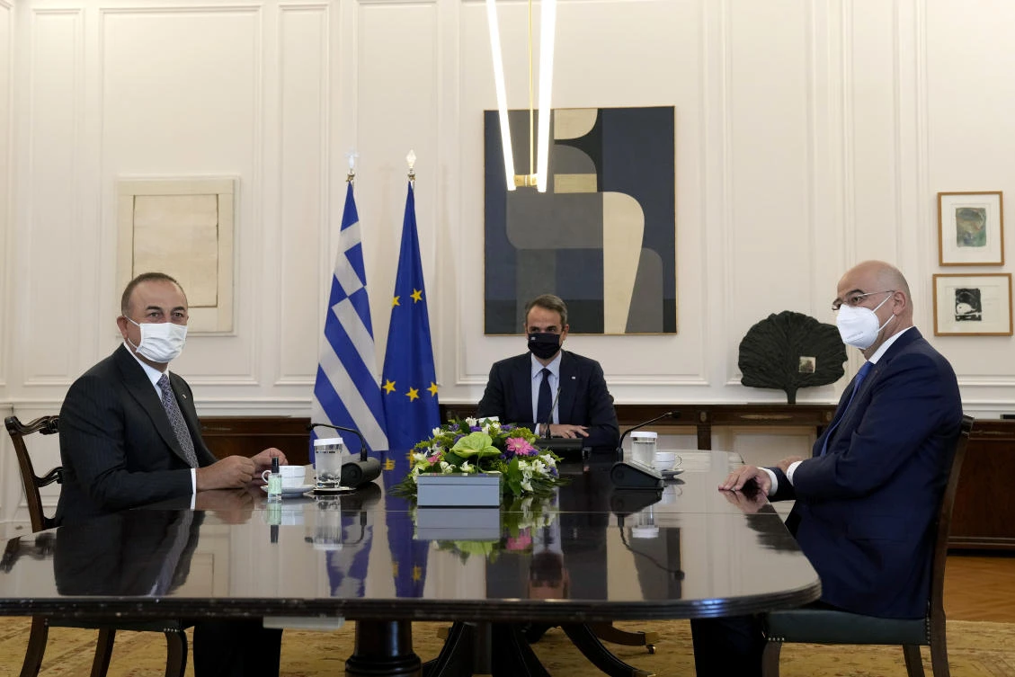 Greek Prime Minister Kyriakos Mitsotakis, center, with his Turkish counterpart Mevlut Cavusoglu, left, and the Greek Foreign Minister Nikos Dendias during their meeting at Maximos Mansion in Athens, Monday, May 31, 2021. (AP)