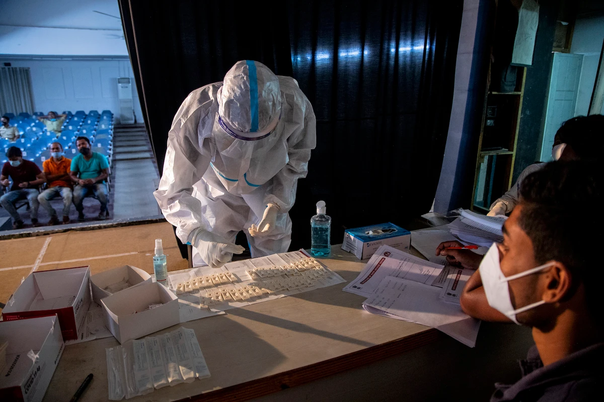 A health worker performs a rapid test for COVID-19 after collecting the nasal swab sample of an election official on May 1, 2021. (AP)