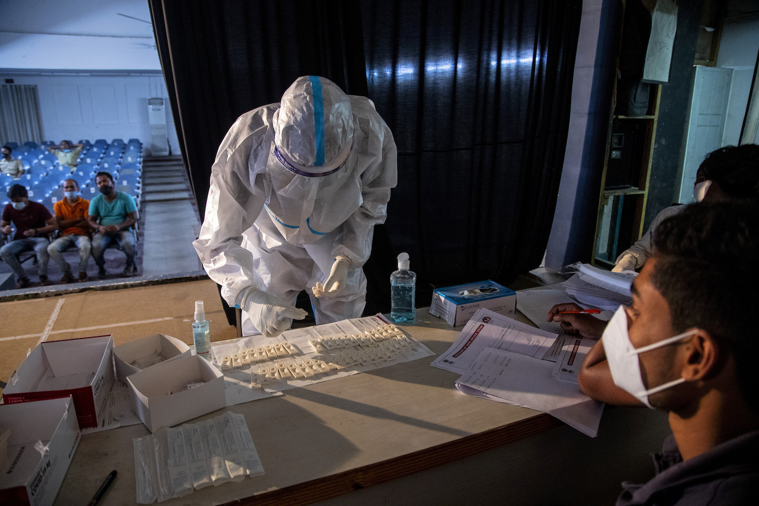 A health worker performs a rapid test for COVID-19 after collecting the nasal swab sample of an election official on May 1, 2021. (AP)