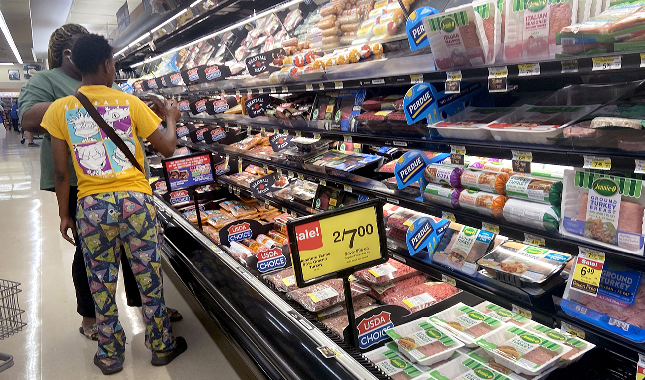 Customers shop for meat at a supermarket on June 10, 2021 in Chicago, Illinois. (AFP)