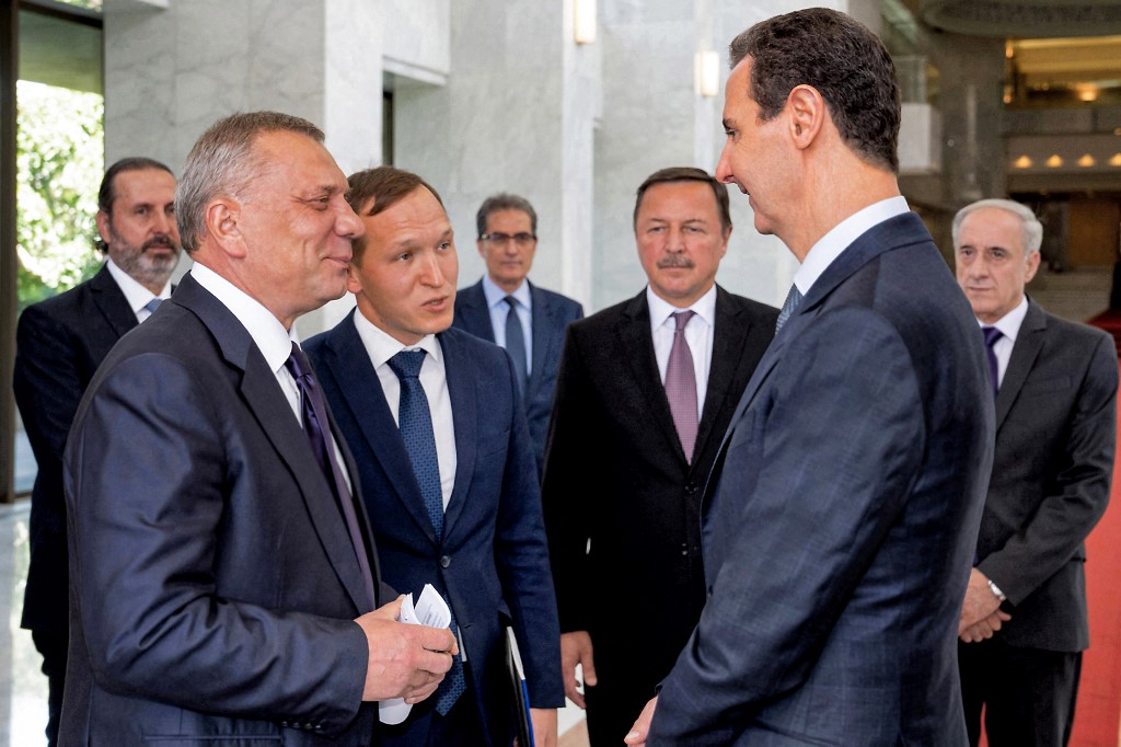 Syria's President Bashar Al-Assad (R) receives Russia's Deputy Prime Minister Yuri Borisov in Damascus. (File/AFP)