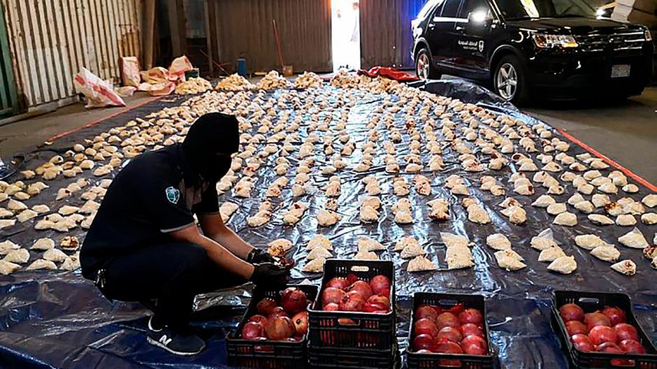 Saudi customs officers discovered millions of amphetamine pills in a shipment of pomegranates that had arrived from Lebanon in April 2021. (AP Photo)