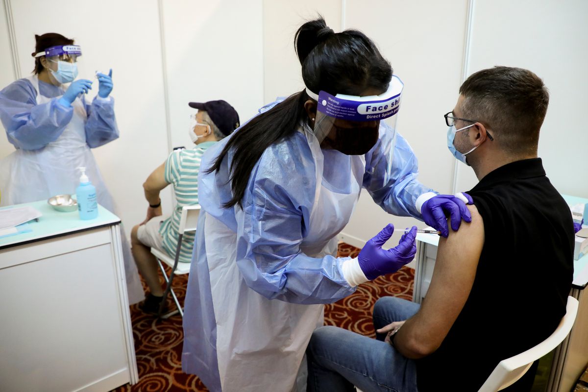 People receive AstraZeneca’s COVID-19 vaccine at a vaccination centre in Kuala Lumpur, Malaysia, May 5, 2021. (Reuters)
