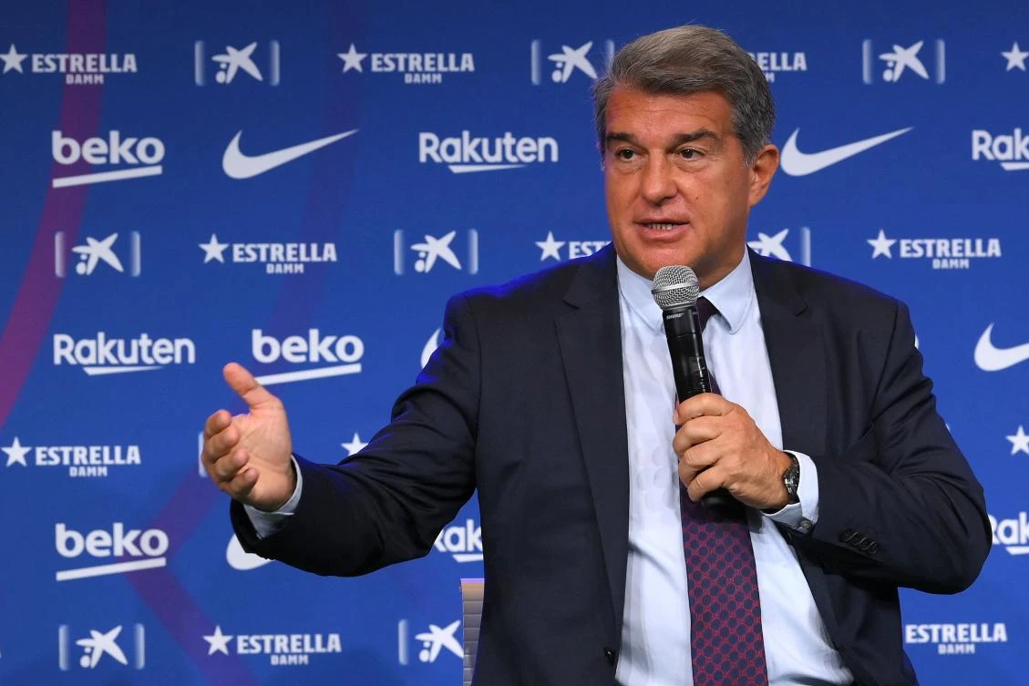 Barcelona president Joan Laporta presenting Manchester City's Spanish ex-defender Eric Garcia as new player at the Camp Nou on Tuesday. Laporta said negotiations with Lionel Messi ‘are going well’ (AFP)