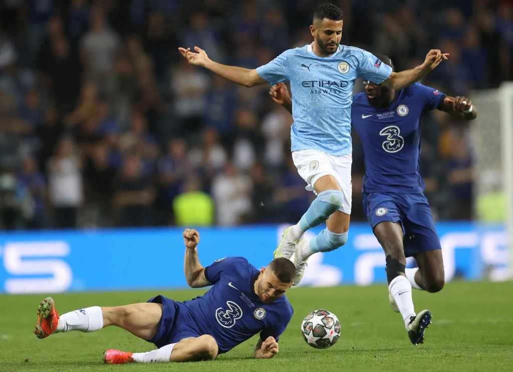 Manchester City's Algerian midfielder Riyad Mahrez (C) jumps over Chelsea's Mateo Kovacic (L) as defender Antonio Ruediger (R) chases them during the UEFA Champions League final. (AFP)