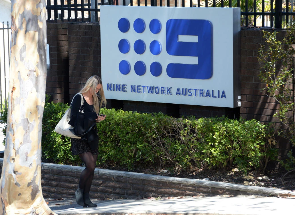 A woman walks past the entrance to the Channel Nine television network complex near Sydney. (File/AFP)
