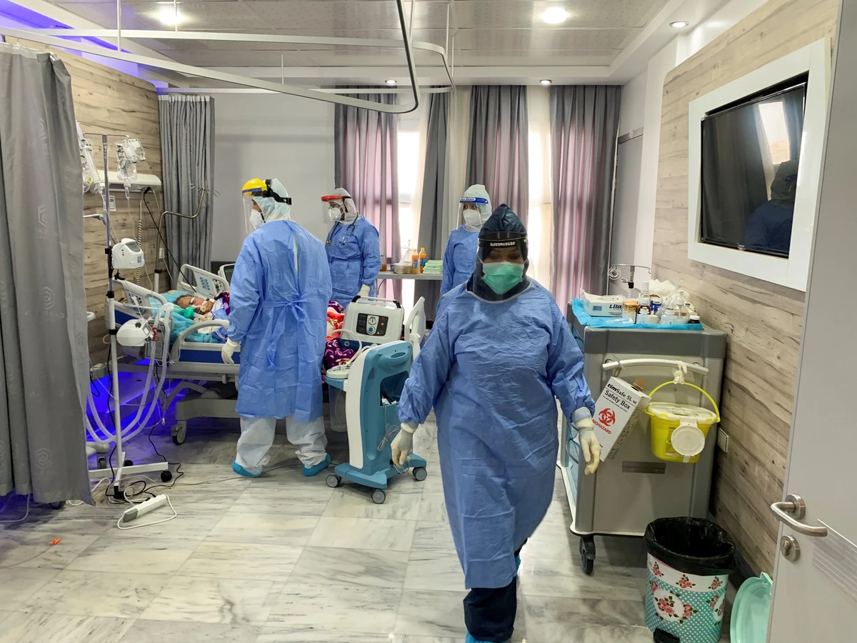 Hamza Abdulrahman Jelwal, a supervising nurse, and his teammates care for a patient infected with the coronavirus disease (COVID-19), at a quarantine center, Misrata, Libya, Sept. 7, 2020. (Reuters)