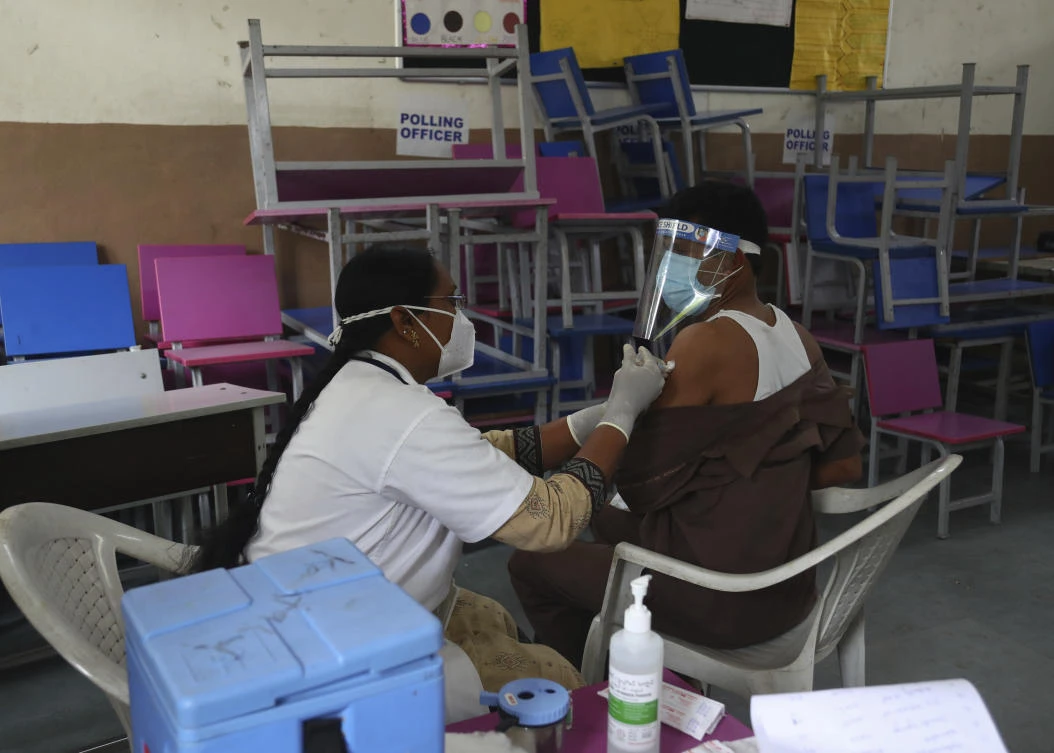 A health worker administers the AstraZeneca vaccine during a special vaccination drive for autorickshaw and cab drivers in Hyderabad, India, Thursday, June 3, 2021. (AP)