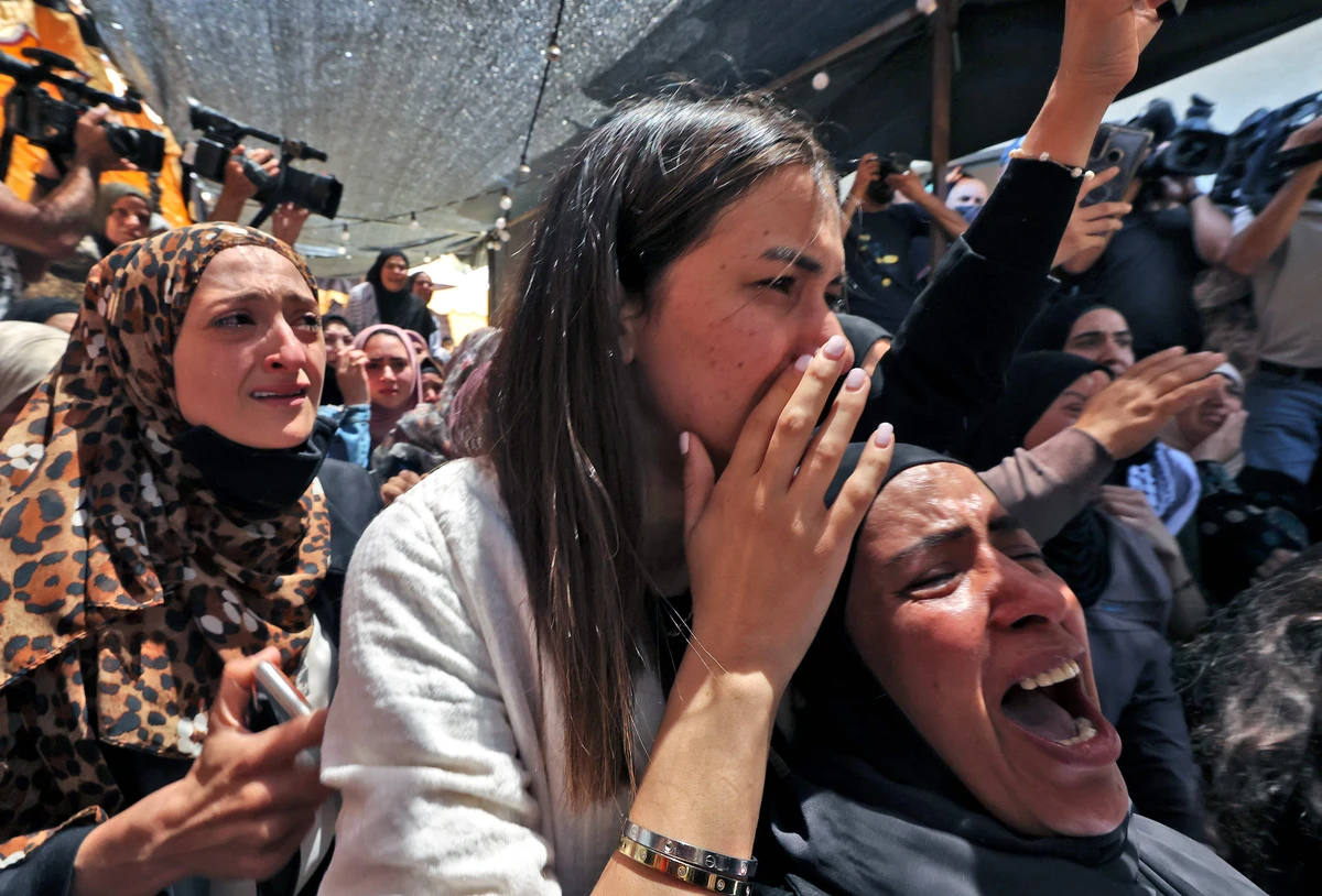 Relatives of Palestinian student Fadi Wahha, who was reportedly shot by Israeli security forces during a protest, mourn during his burial on Wednesday. (AFP)