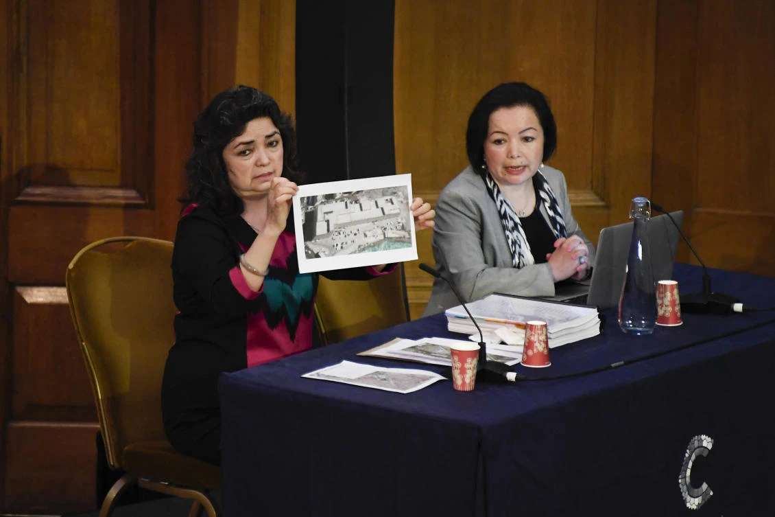 Witness Qelbinur Sidik shows a picture purported to be of a detention camp, to the Panel of the independent Uyghur Tribunal during the first session of the hearings in London, Friday, June 4, 2021. (AP)