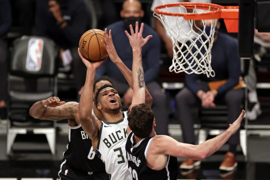 Milwaukee Bucks forward Giannis Antetokounmpo drives to the basket against Brooklyn Nets forward Joe Harris during their NBA game on Jan. 18, 2021, in New York. (AP file photo)