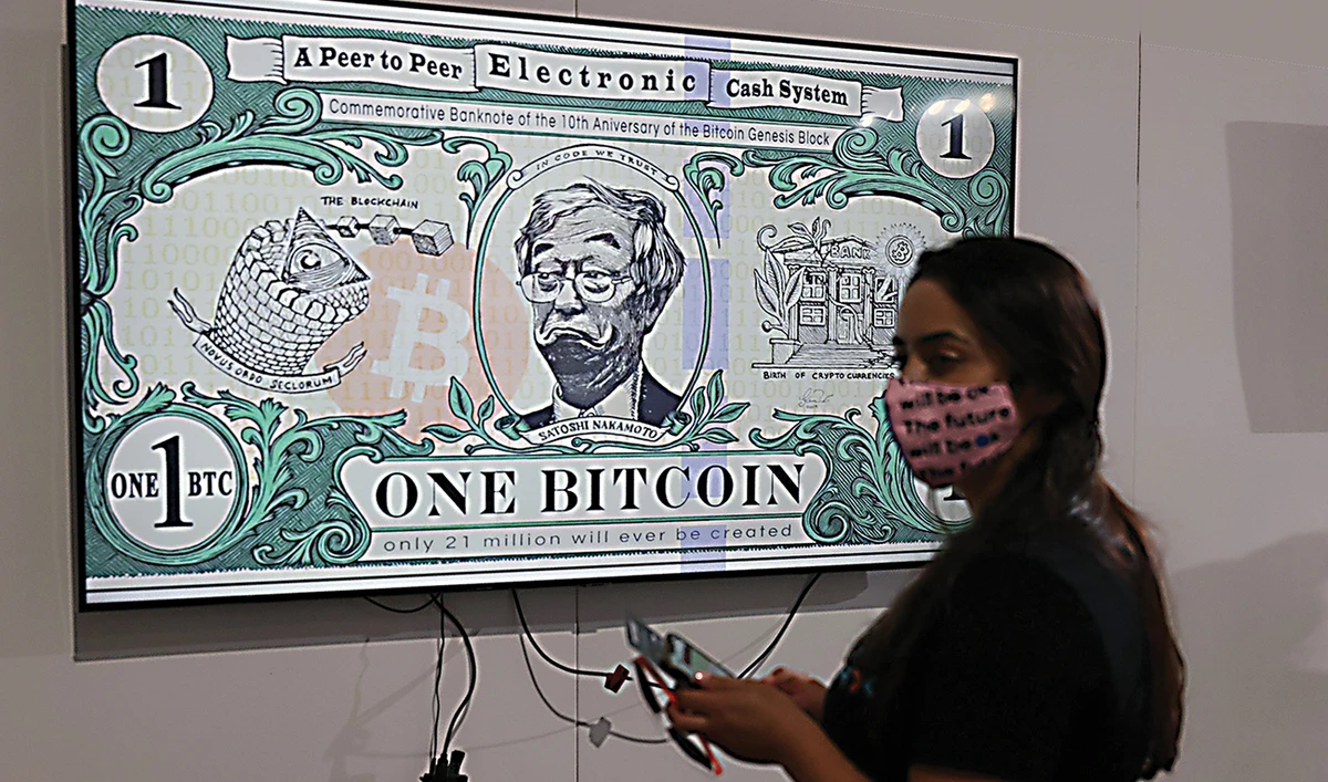 A art piece titled BTC Bank Note by artist Gus GG hangs at the Bitcoin 2021 Convention in Wynwood. (AFP)
