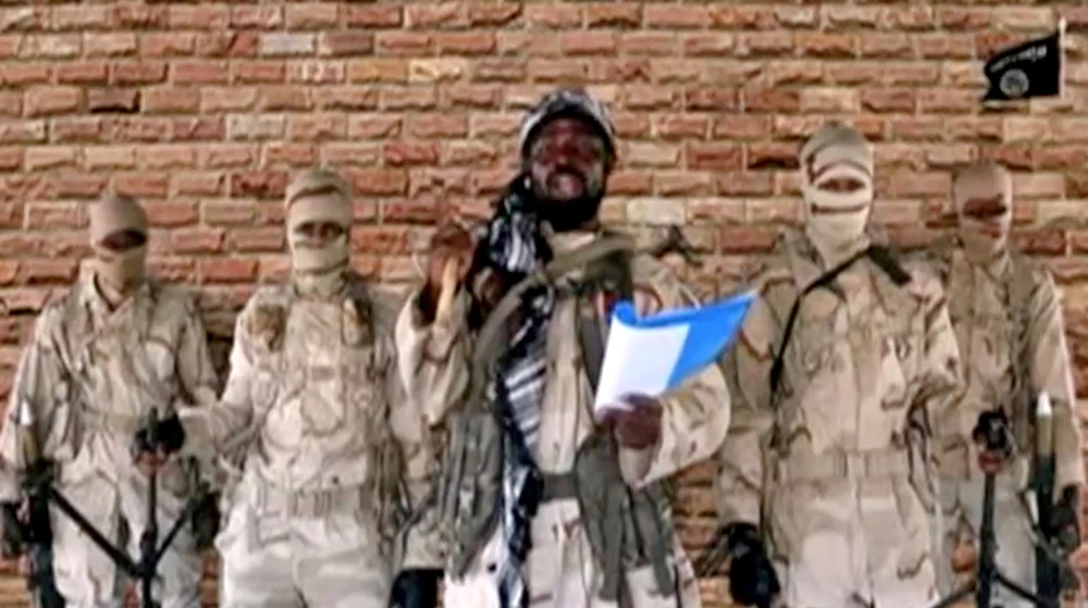 Boko Haram leader Abubakar Shekau speaks in front of guards in an unknown location in Nigeria in this still image taken from an undated video obtained on January 15, 2018. (Boko Haram Handout/Sahara Reporters via Reuters)