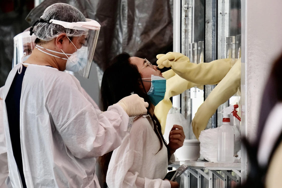 A woman undergoes a swab test for the COVID-19 (coronavirus) at a screening area in New Taipei City, Taiwan. (File/AFP)