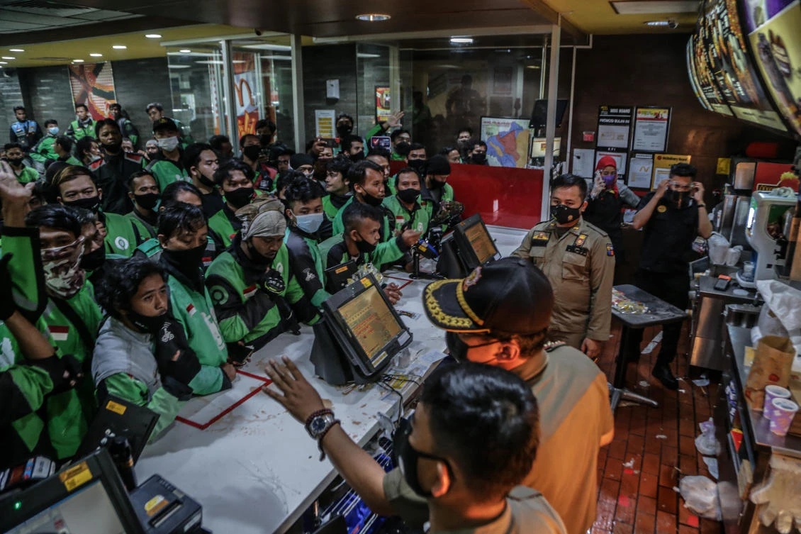 Food delivery riders queue up at a McDonald’s outlet in Bogor on June 9, 2021, to buy the new BTS-meal deal for hungry fans in the K-Pop mad country. (AFP)