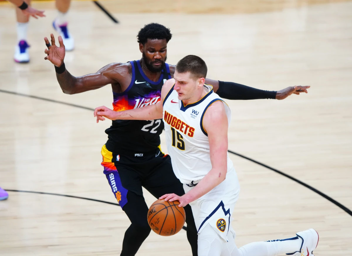 Nikola Jokic drives against Deandre Ayton during Game 2 their 2nd round playoff series on June 9, 2021. (Mark J. Rebilas-USA TODAY Sports)