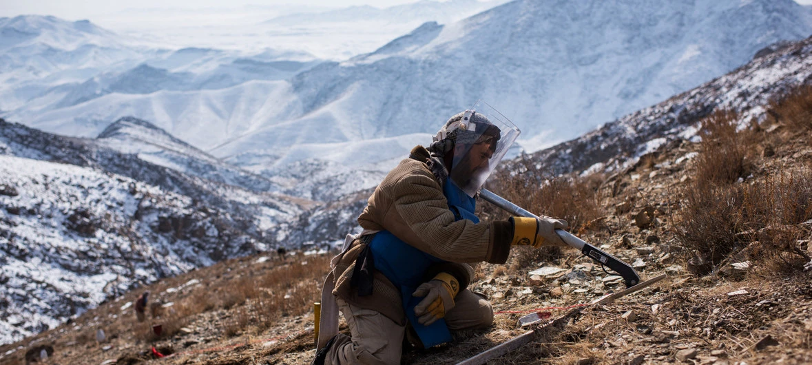 An explosives specialist conducts mine clearance operations after detecting a piece of metal in Afghanistan, where 2,300 casualties as a result of landmines were reported in 2017 alone. (File/UN)