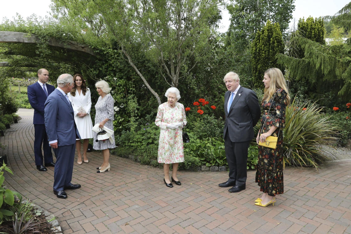 Britain's Queen Elizabeth II, Prince Charles, Camilla, the Duchess of Cornwall, Prince William and Kate the Duchess of Cambridge stand with Boris Johnson and Carrie, during a reception for the G7 leaders in Cornwall, England. (AP)