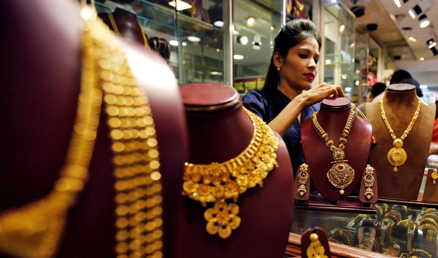 A salesperson attends to a customer (not pictured) inside a jewelery showroom in Mumbai, India. (REUTERS file photo)