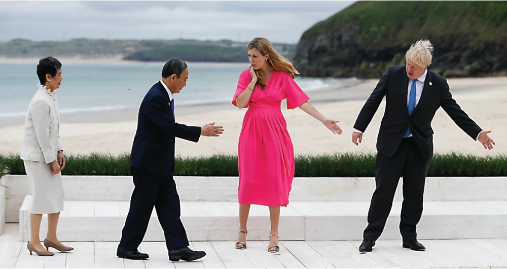 Britain’s Prime Minister Boris Johnson and his spouse welcome Japan’s Prime Minister Yoshihide Suga during the G7 summit in Carbis Bay. (Reuters)