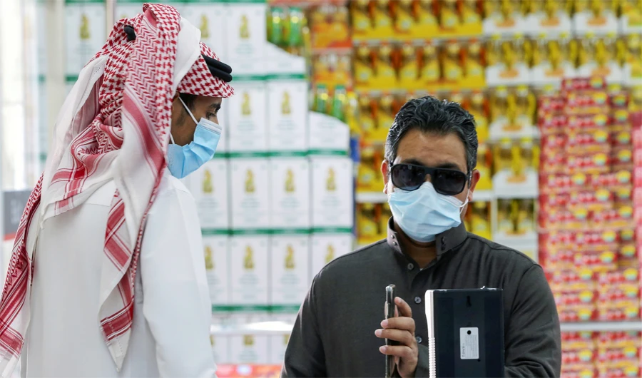 A man displays his details on his mobile phone using the Tawakkalna app as he enters a mall in Riyadh, Saudi Arabia. (REUTERS)