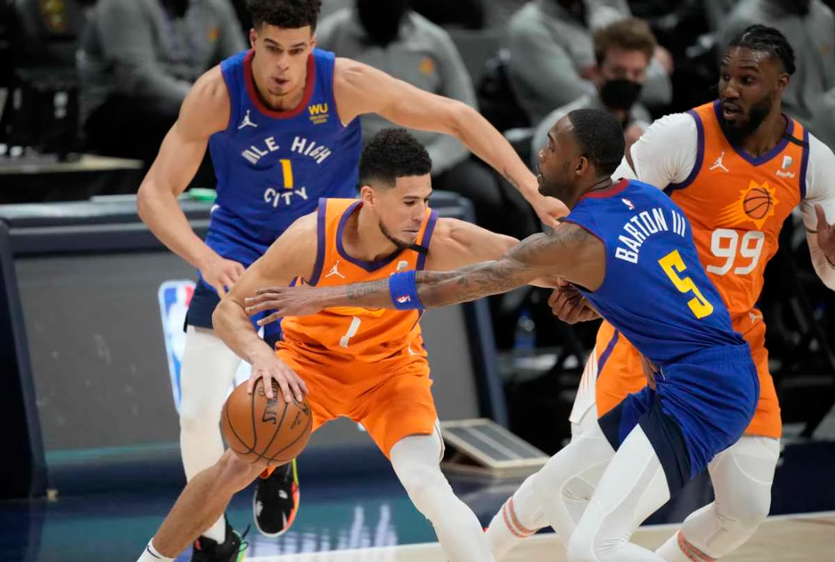 Phoenix Suns guard Devin Booker drives against the Denver Nuggets during Game 3 of their NBA second-round playoff series on June 11, 2021, in Denver. (AP Photo/David Zalubowski)