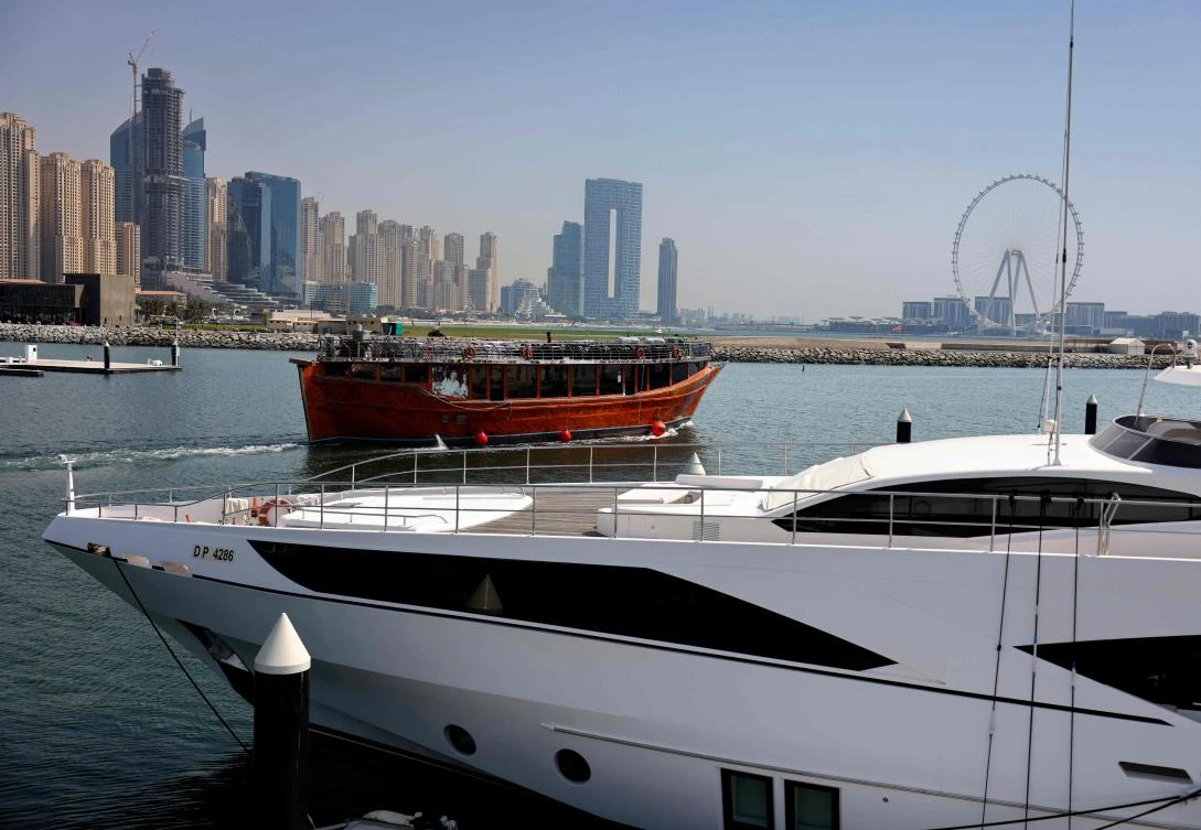 A restaurant cruiser sails by the Dubai Marina Beach in the eponymous Gulf emirate of the UAE. (AFP)
