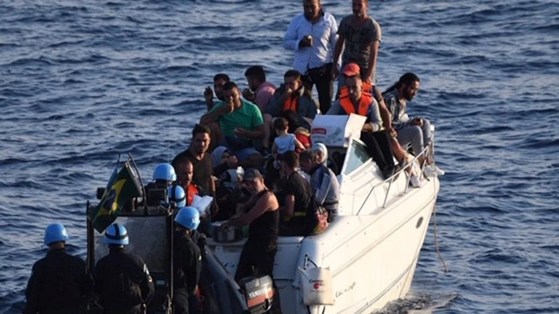 Brazilian Navy boat from UNIFIL in Lebanon approaches a boat overcrowded with migrants in the Mediterranean Sea in October, 2018. (UNIFIL via AP)