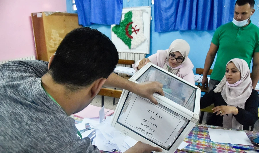 Algerian elections staff count ballots for parliamentary elections at a polling station in Bouchaoui, on the western outskirts of the capital Algiers, on June 12, 2021. (AFP)