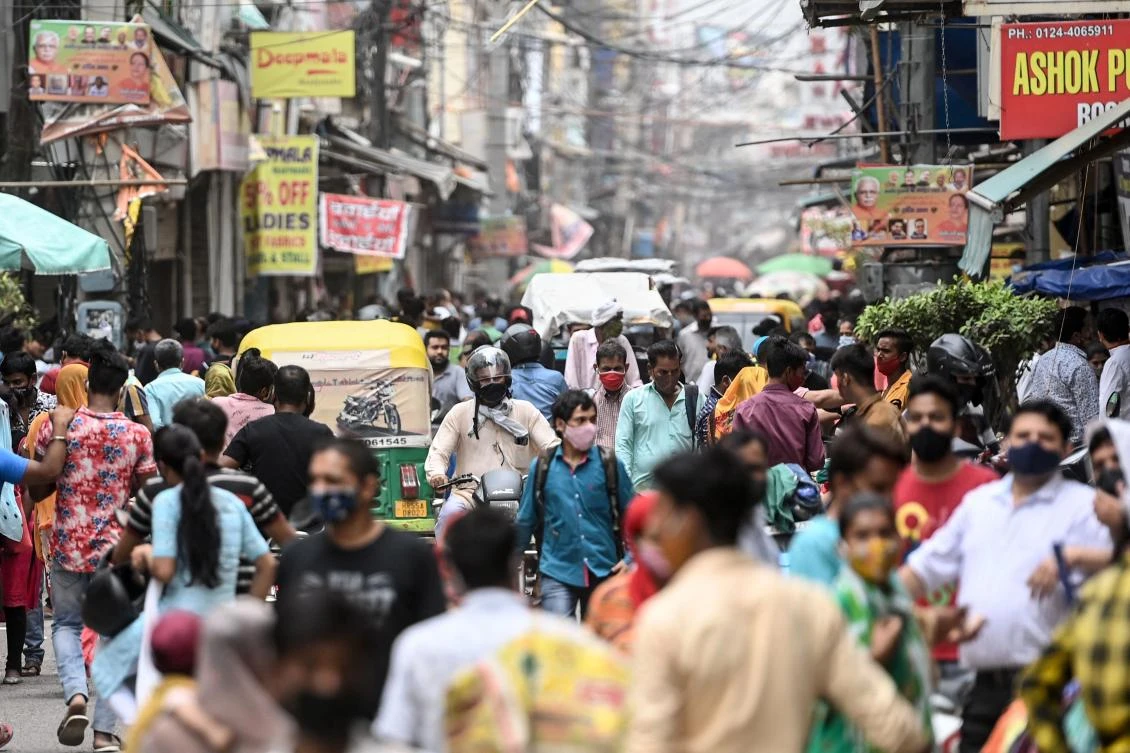 People shop at a market after the government eased restrictions as the number of new Covid-19 coronavirus infections dropped, in Gurgaon on June 13, 2021. (AFP)