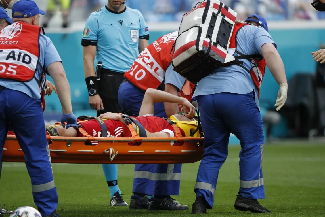Paramedics carry on a stretcher Russia’s Mario Fernandes after his injuring during Euro 2020 match between Russia and Finland at the Saint Petersburg stadium. (AP)