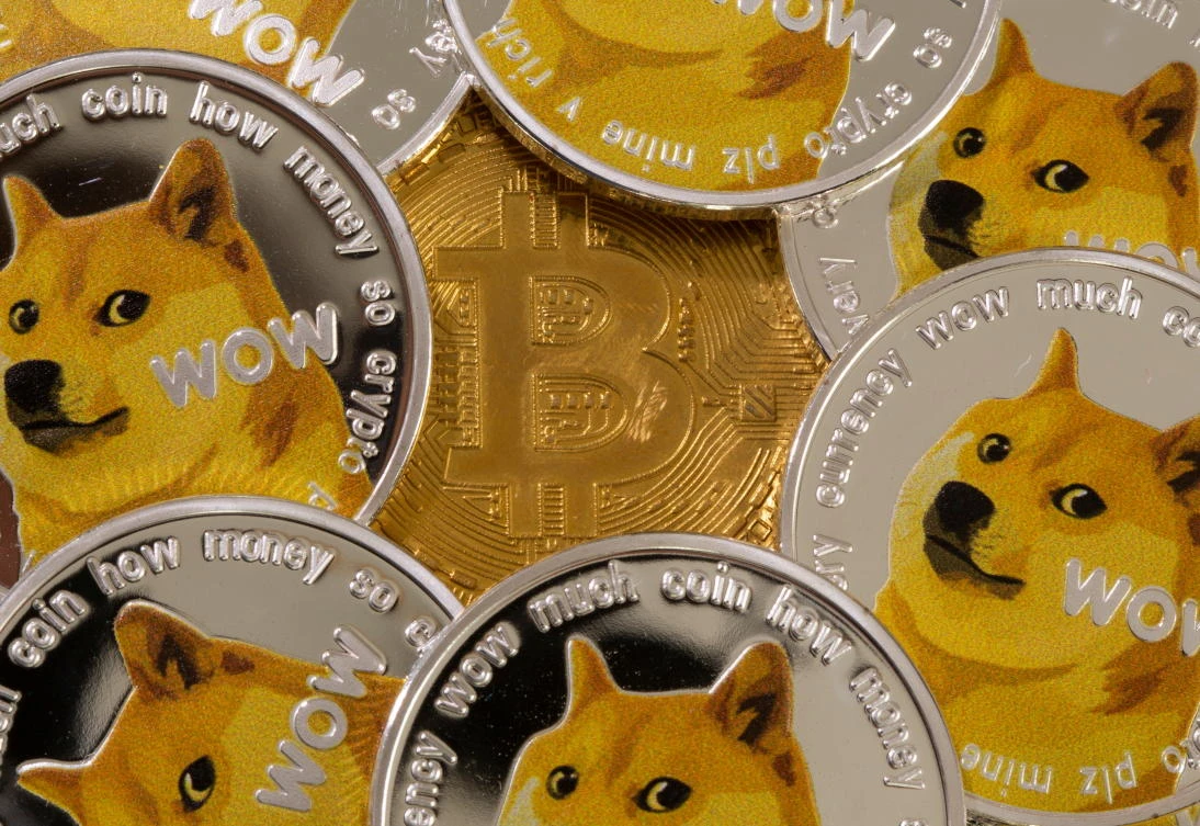 Representations of the virtual currency Dogecoin and Bitcoin are seen in this illustration. (Reuters)