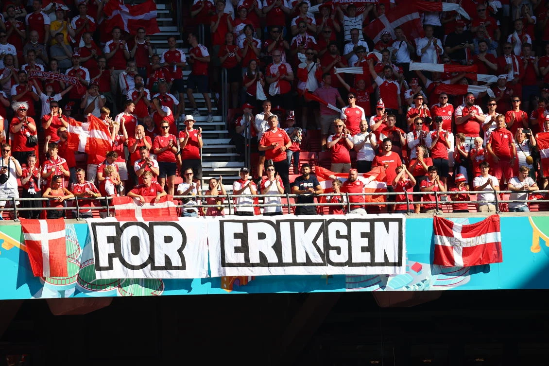 Denmark supporters display a banner for Christian Eriksen, who collapsed during the match against Finland, prior to the Euro 2020 match between Denmark and Belgium at Copenhagen’s Parken stadium. (AP)