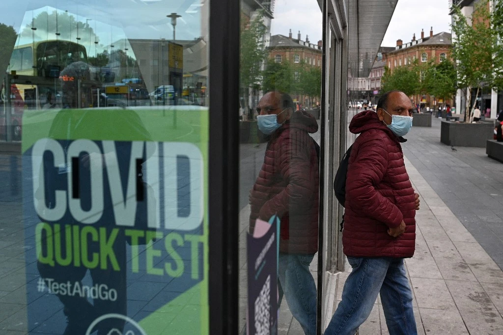 Headache now tops the list of most common symptoms, with 60 percent of people who test positive experiencing one. (AFP)