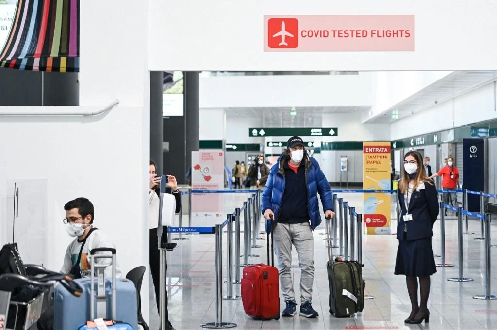A passenger arrives at Malpensa Airport in Milan April 3, 2021 after disembarking from the first ‘COVID-tested’ and ‘quarantine-free’ flight from New York to northern Italy. (AFP)