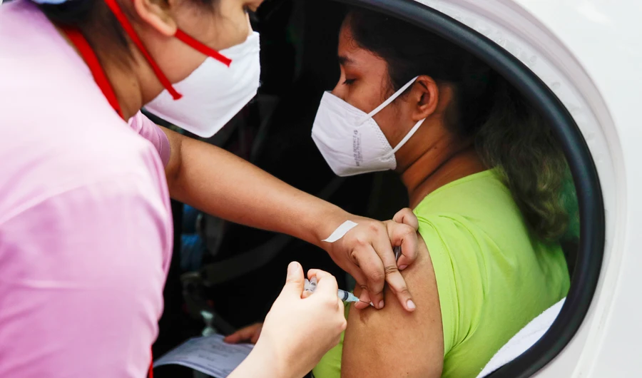 In this June 9, 2021, file photo, a health worker administers Covishield, Serum Institute of India's version of the AstraZeneca vaccine, during a drive-in vaccination program in Kolkata, India. (AP)