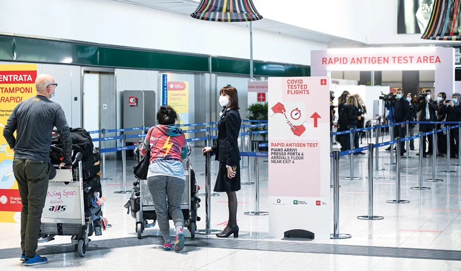 Passengers undergo a rapid antigen swab test for COVID-19 at Malpensa Airport in Milan. (AFP)