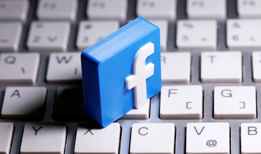A 3D-printed Facebook logo is seen placed on a keyboard in this illustration taken March 25, 2020. (REUTERS)