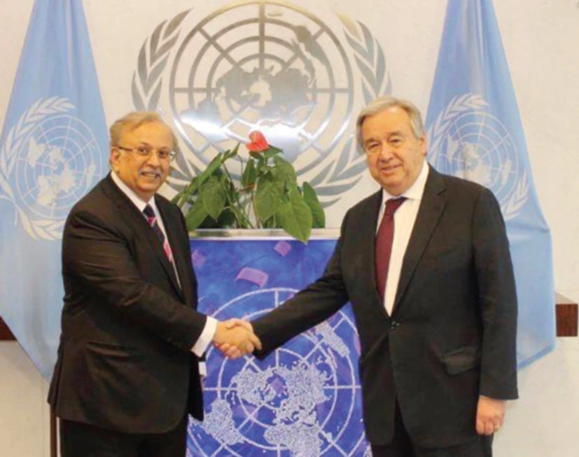 Saudi envoy Abdallah Al-Mouallimi, left, wishes Antonio Guterres godspeed on his second term as UN secretary-general. (SPA)