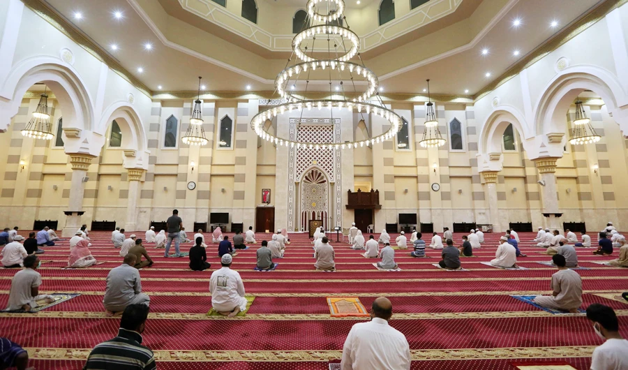Worshippers, keeping a safe distance from one another, perform the dawn prayer at a mosque in the Saudi holy city of Makkah on June 21, 2020. (AFP)