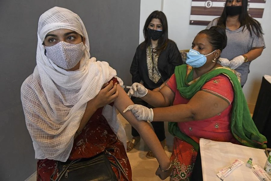 A health worker inoculates a woman with the jab of Covishield vaccine against the Covid-19 coronavirus during a vaccination camp held at a salon in Amritsar on June 20, 2021. (File/AFP)