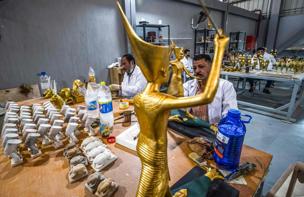 Technicians paint replicas of an Ancient Egyptian statues being fabricated at the Egyptian government's Konouz (Treasures) factory east of Cairo. (AFP)