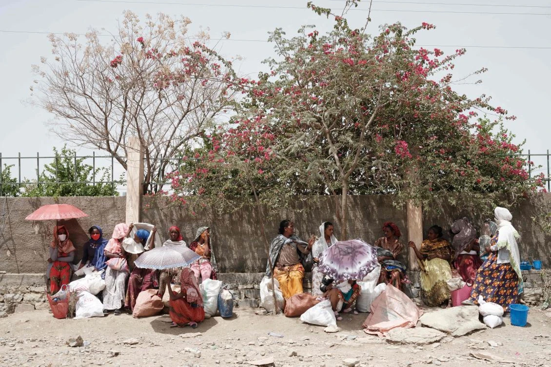 Above, women who fled the violence in Ethiopia’s Tigray region receive a food distribution organized by the local NGO Relief Society of Tigray in Mekele on June 19, 2021. (AFP)