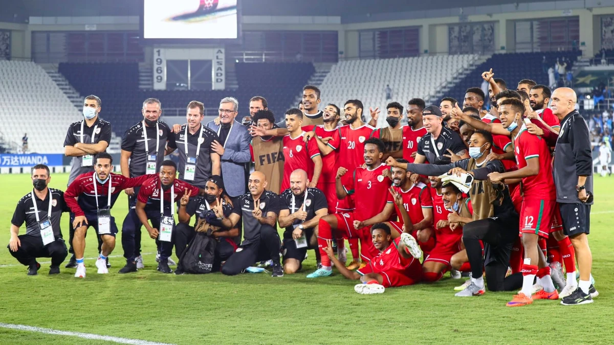 Oman’s players and technical staff celebrate qualifying to the 2021 FIFA Arab Cup. (Oman Football Association)
