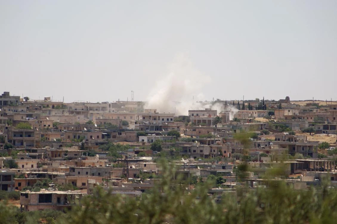 Smoke billows following reported bombardment by government forces in the Syrian northwestern town of Barah in Idlib on June 21, 2021. (AFP)